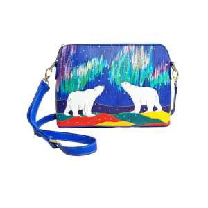 Sky Watchers art bag featuring Dawn Oman’s polar bear design under a colorful northern lights sky, with blue strap and gold-tone hardware.